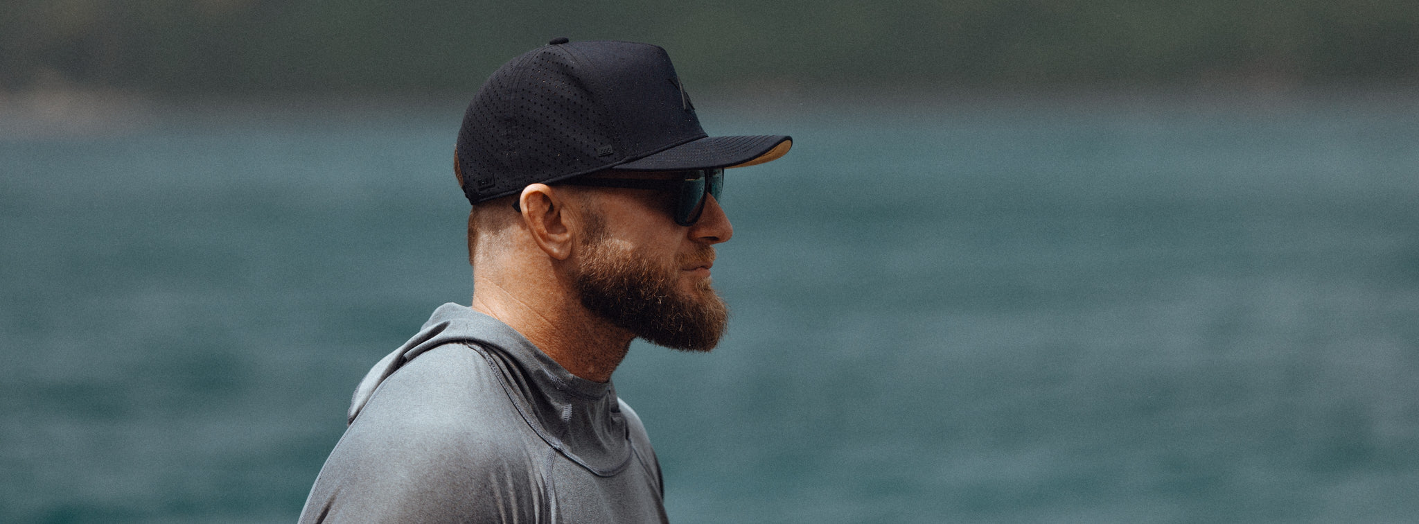 XG Cargo x Suay Apex Hat in black, worn lakeside